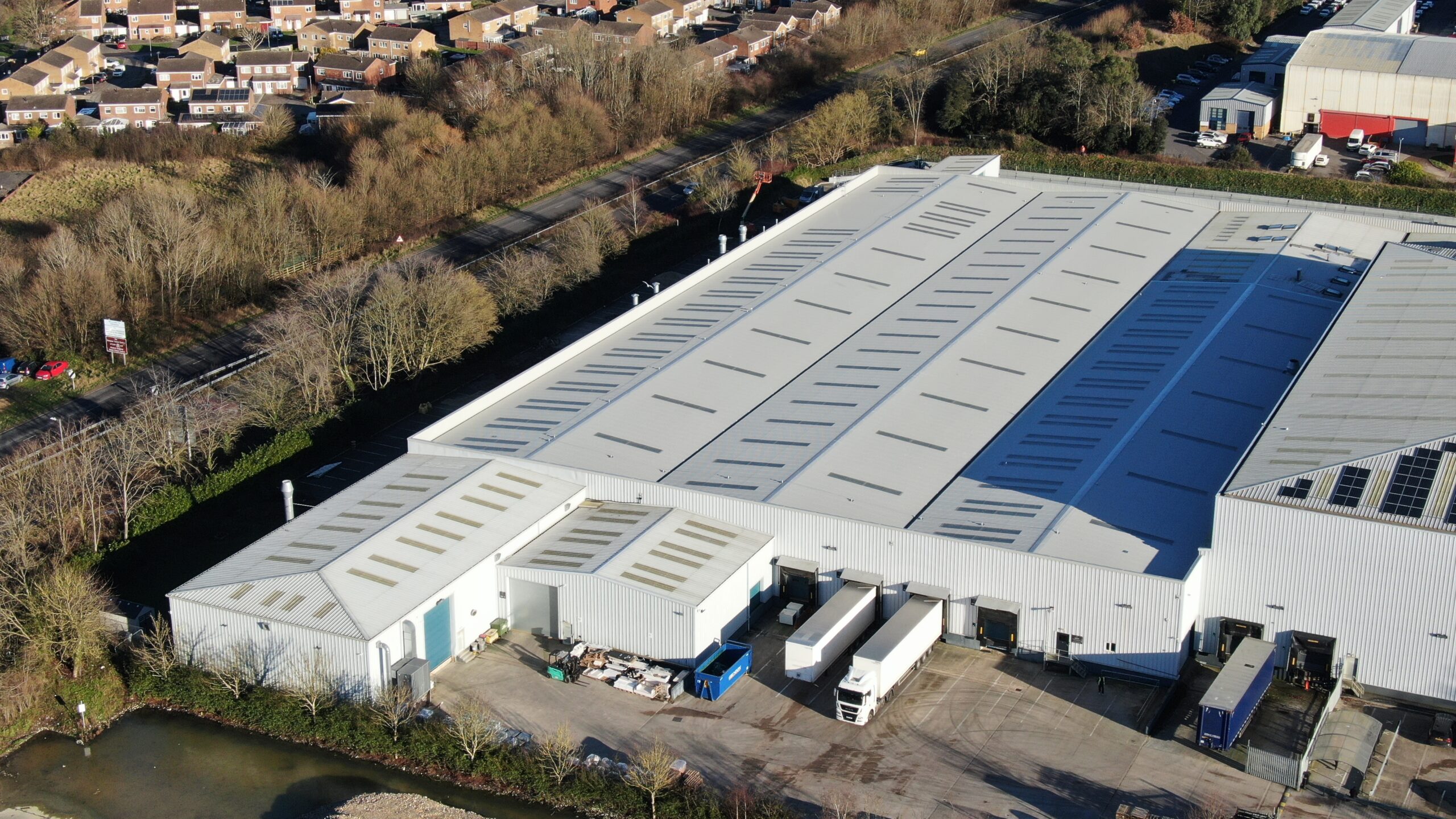 A large warehouse with an asbestos roof.